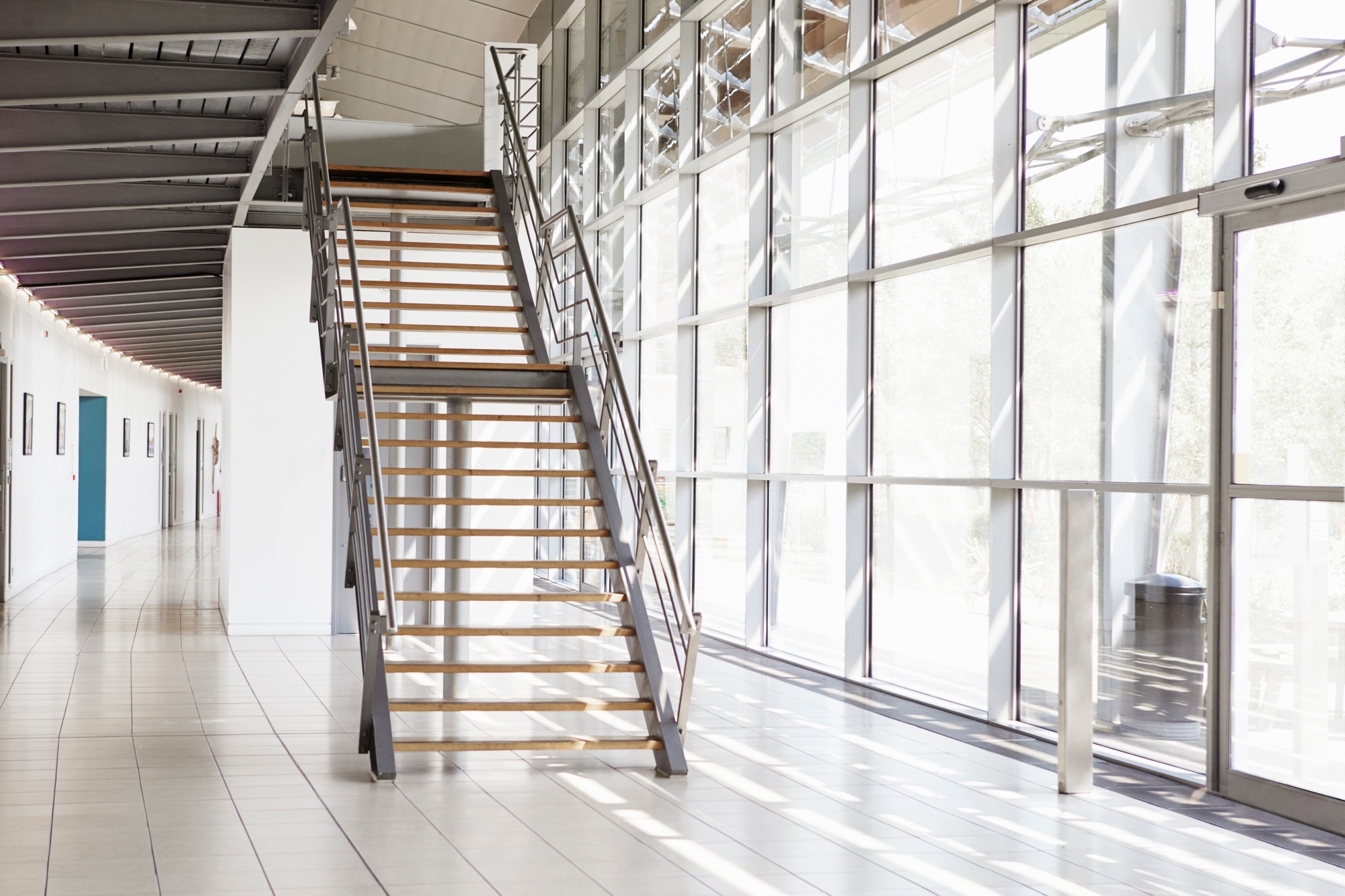 Modern interior of business with glass walls and staircase